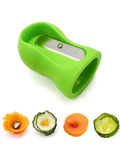 Spiral slicer, green handheld with stainless steel blade for carrot and cucumber spirals; four veggie shapes shown.