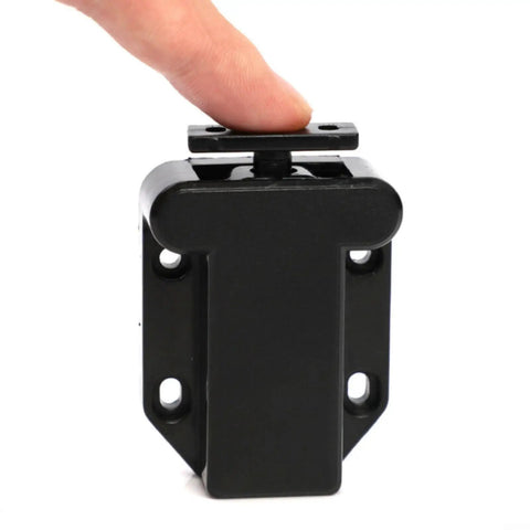 Push To Open Cabinet Latch With Touch Release, black finish, shown with finger pressing touch feature, minimalist hardware.