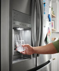 Person using refrigerator water dispenser with Plug And Play PureSource Ultra Water And Air Filter Kit With PureAir Ultra II And PureFresh Replacements