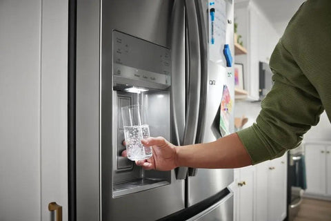 Person using refrigerator water dispenser with Plug And Play PureSource Ultra Water And Air Filter Kit With PureAir Ultra II And PureFresh Replacements