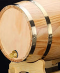 Brass Garden Hose Bulkhead Fitting Kit With Plugs attached to wooden barrel with metal bands