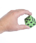 Hand holding green foam dice with number dots from Bulk Pack Of 36 1.5 Inch Foam Dice In Assorted Colors For Kids And Classrooms Big Fun Durable