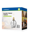 Box of Lit Skeleton Skull Glass Table Torch for Outdoor Patio Decor with image of skull-shaped glass lantern and cap.