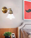 Straight Up Stunning Nordic Metal Wall Sconce With Adjustable Hand Blown Glass Shade And No Fuss Switch E27 One Light Wall Lamp for Bedroom or Dining Room Setting, brass finish and clear shade.