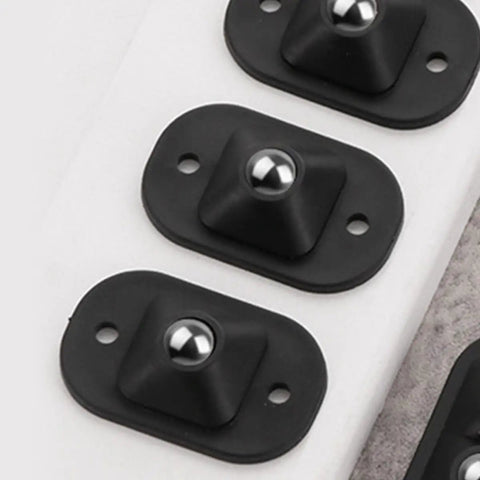 Self Adhesive Black Appliance Caster Wheels With 360 Degree Swivel Design Touch Down Roll Easy Low Profile Rollers For Kitchen Fridges Heavy Duty Storage Trays close-up of black base with ball for smooth rolling.