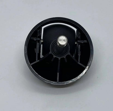 Close-up of black swivel wheel replacement for robot vacuum; circular plastic wheel with central metal axle.