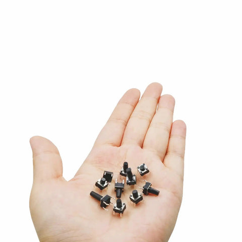 Hand holding miniature push buttons from 250 Piece 10 Value 6x6mm Tactile Push Button Switch Kit For Arduino And Breadboard Projects.