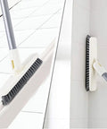 Long Handle Grout Scrub Brush With Rotating Head For Tile Floors And Shower Corners shown scrubbing tile edges and walls.