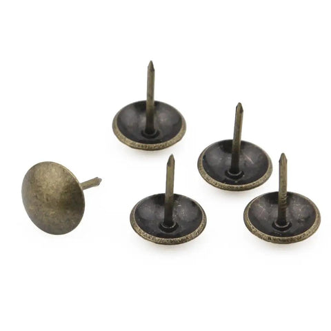 Top Shelf 100 Piece Set Of Antique Bronze Upholstery Nails And Decorative Furniture Tacks in various angles, showing their size and detail.