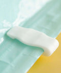 Close-up of white sealing clip on vacuum storage bag, part of Ten Pack Vacuum Storage Bags Sealing Clips Set With Reusable Zipper Grips