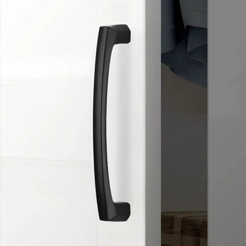 Top Shelf 10 Pack 5 Inch Matte Black Cabinet Pulls Featuring Hella Sturdy Zinc Alloy Body And Smooth Grip Design on cabinet door.