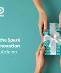 Hands exchanging a gift wrapped in Arduino-themed paper with text 'Gift the Spark of Innovation with Arduino'.