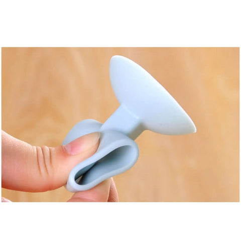 Close-up of Silicone Suction Cup Door Stopper Wall Protector With Noise Reduction Pad held in hand, showing soft touch material.