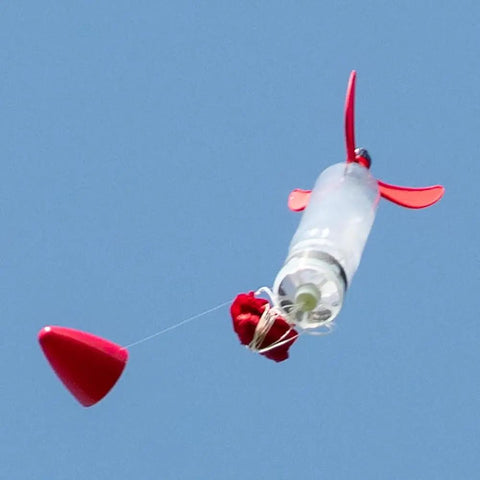 Screw On Water Rocket Fins With Parachute Kit For 2 Liter Bottles Fits 95 Percent Of Launchers No Tools Required Easy Screw On Assembly Includes 24 Inch Red Ripstop Parachute Ready To Fly in flight with red fins and parachute deployment.