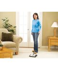 Lightweight Manual Carpet And Hard Floor Sweeper Featuring Dual Rotating Brush Roll Plus Corner Edge Brushes being used on carpet.