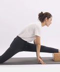Premium Natural Solid Wood Yoga Block With Rounded Corners And Slick Grip For Legit Balance Training And Killer Flex Stretches And Top Shelf Core Conditioning Sessions used for stretching leg.