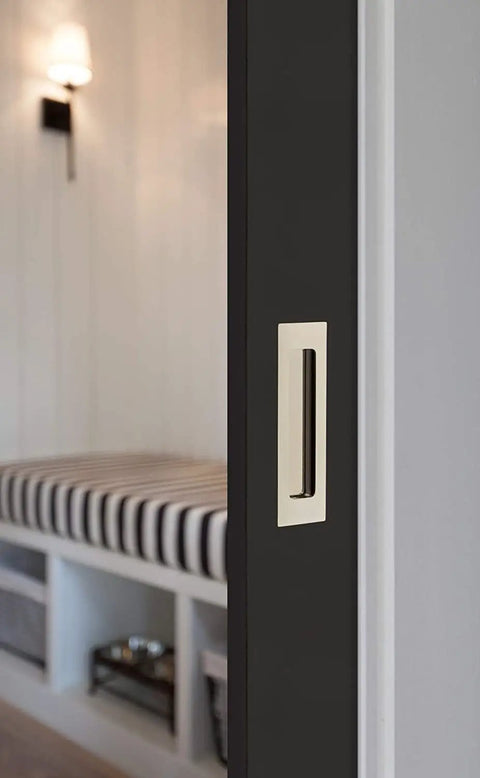 Direct Hit Modern Rectangular Flush Door Pull With Slick French Antique Finish Built Tough Solid Hardware For Interior Doors And Cabinets Smooth Operation And One Three Quarter By Six Inch Mounting mounted on a sleek black door.