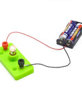 Hella Bright E10 Mini Light Bulbs 10 Pack Screw Base Indicator Lamps connected to a battery for a circuit experiment in a workshop.