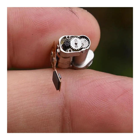 Close-up of a small Precision Stepper Motor Electronic Starter with Planetary Metal Gearbox on a fingertip