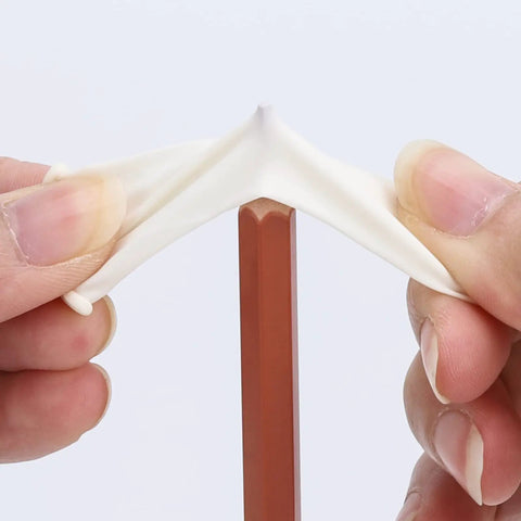 Stretching a small latex fingertip glove over a pencil showing flexibility. Latex Finger Cots 400 Count Small Disposable Fingertip Gloves Anti Static Flexible Rolled Design For Easy Slip On Comfort And Protection For Delicate Work When Handling Small Parts.
