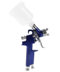 Heavy-Duty 0.8mm Pneumatic Airbrush With 125ml Gravity Feed Cup showing ergonomic grip and precise nozzle for detailing work.