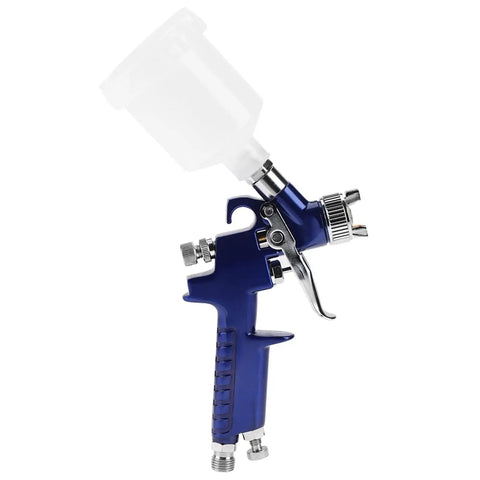 Heavy-Duty 0.8mm Pneumatic Airbrush With 125ml Gravity Feed Cup showing ergonomic grip and precise nozzle for detailing work.