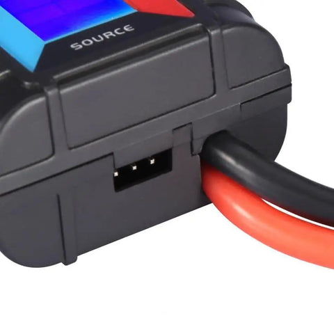 Close-up of Badass No Sweat Plug And Play 200A Digital Wattmeter with red and black cables connected for measuring.