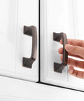 Hand installing oil rubbed bronze square arch pull on white cabinet with 3 inch spacing, 10 pack, 76mm