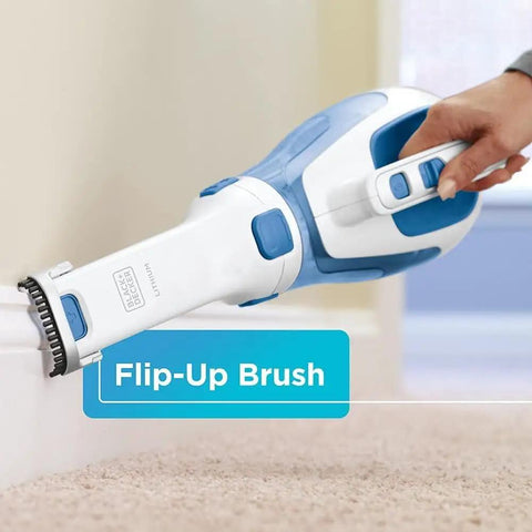 Hand using Slick Cordless Dustbuster Handheld Car Vacuum 12V with rotating nozzle and slim crevice tool on carpet edge.