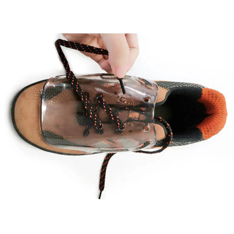 Top view of transparent metatarsal guard on work boot with laces, showing non-conductive polycarbonate material attachment.