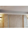 Sleek Led Wall Sconce Textured Crystal Glass Rod Shade Brushed Steel Frame illuminating a hallway with warm light.