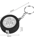 Two Piece Measuring Wheel And Retractable Tape Featuring Cm And Foot Dial And Heavy Duty Click Lock For Slick Fence Lines Tire Gauges And Quick Site Markouts That Handle Hard Labor Like A Champ And Ride Easy In Your Trunk keychain shaped like a tire with a silver wheel design.
