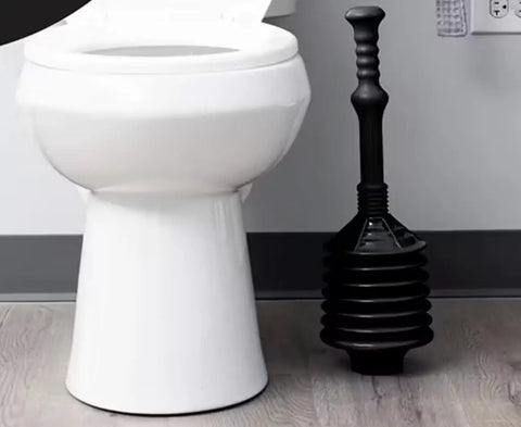 No Sweat Bellows Toilet Plunger Delivers Maximum Thrust For Stubborn Blockages Anti Splash Action For Low Flow Drains Hella Effective Power Plunger With 21 Inch Handle next to a toilet.