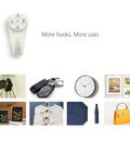No Trace Picture Hangers For Concrete And Drywall 25 Pack Invisible Nail Hangers holding keys, clock, frames, and art.
