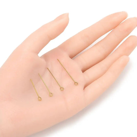 Raw Brass Eye Pins 30mm 1.2 Inch For Jewelry Beading Craft Making Set Of 200 Unplated Uncoated 0.8mm 20 Gauge Findings Ideal For DIY Jewelry And Beading Projects Gift Making, four raw brass eye pins in hand