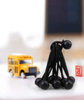 30 Pack 4 Inch Heavy Duty Black Bungee Cords For Tarp Canopy Tent Camping Gear on desk with toy school bus