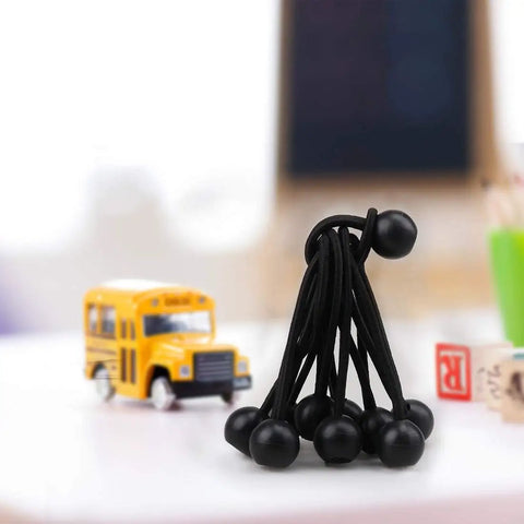 30 Pack 4 Inch Heavy Duty Black Bungee Cords For Tarp Canopy Tent Camping Gear on desk with toy school bus