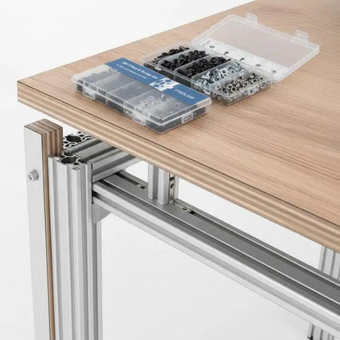 Ultimate M5 T Nut And Black Screw Kit For 6mm T Slot Aluminum Extrusion on wooden table with open case showing components