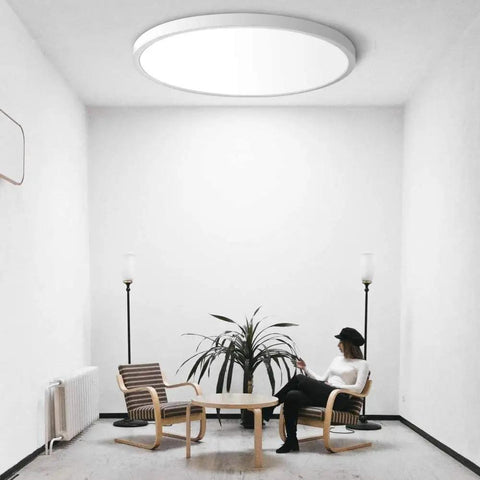 12 Inch LED Flush Mount Ceiling Light Black 5000K Daylight White 24W 240W Equivalent Dope Ultra Thin Flat Modern Ceiling Fixture 3200 Lumen Ceiling Lamp For Bathroom Kitchen Bedroom Living Room Hallway installed in a white room with modern furniture.