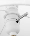 Close-up of the socket and switch design on the Paloma Table Lamp By Novogratz X Globe, white fabric shade visible.