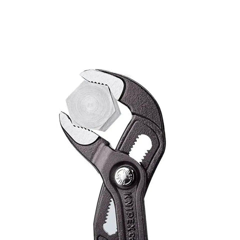 Heavy Duty 22 And A Half Inch Cobra Style Water Pump Pliers And Pipe Wrench gripping a hex nut, ultra durable metal build.