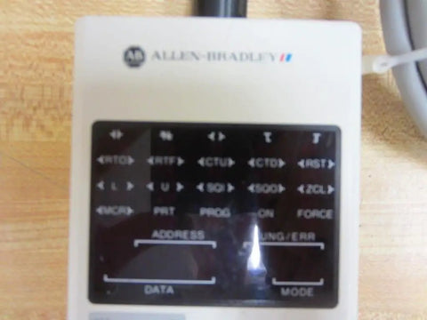 Close-up of 1745-PT1/A SLC SER A Interface Converter Programmer showing address, data, and mode labels, part of PLC tool.