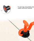 Close-up of orange and black reusable leveler from Tile Leveling System Kit 1/16 Inch Reusable for DIY and Pros in use on a tile surface.