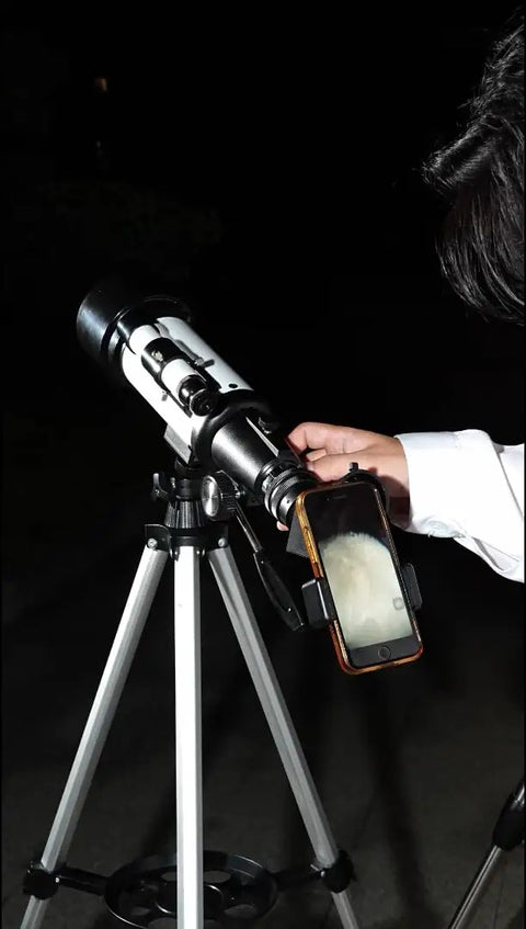 High Powered 150X Portable Telescope With 70mm Aperture HD Refractor Dope Optics Tripod Phone Adapter in use for stargazing