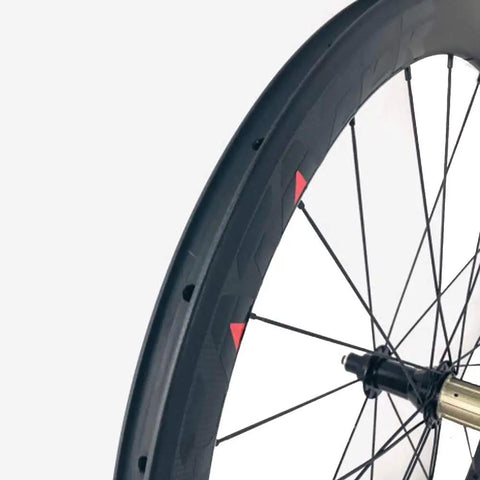 Close-up of Carbon Road Bicycle Wheelset Clincher 50mm Deep Rim Basalt Brake Surface 3K Weave With Novatec ABG Hub.