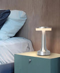 Cordless Metal Desk Lamp with Touch Sensor on bedside table, sleek silver LED, 3 color temperature modes, night light for nursery.