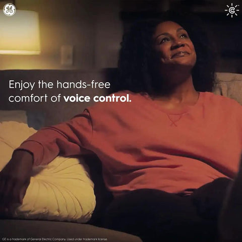 Person relaxing in dimly lit room, showcasing voice control feature for Smart Toggle Light Switch With Neutral Wire No Hub Needed Easy Install WiFi And Bluetooth Control 2.4 GHz Connectivity Works With Alexa And Google Assistant 1 Pack Quick App Scheduling And Scenes For Traditional Bulbs.