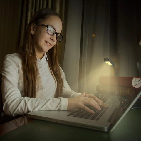 Clip-On Reading Light for Books in Bed, Car and Travel, 3000K Warm LED, illuminating a girl's study area, portable lamp