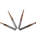 Four copper-tipped carbide end mills with silver shanks; dual-edge taper and ball end for CNC engraving