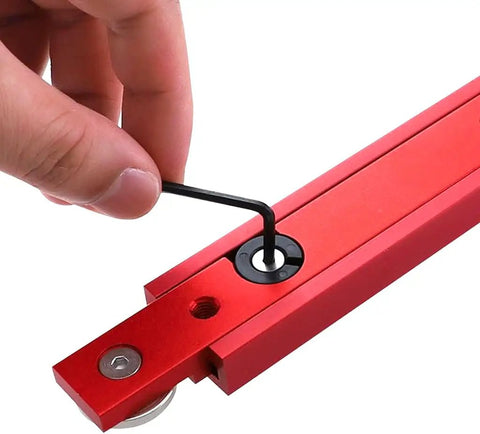Heavy Duty Anodized Aluminum Miter Bar And T Slot Track Rail Featuring Rock Solid Build And Ultra Smooth Glide Designed For Beefy Woodshop Jigs Sleds Router Tables 300mm Red being adjusted with an allen wrench.